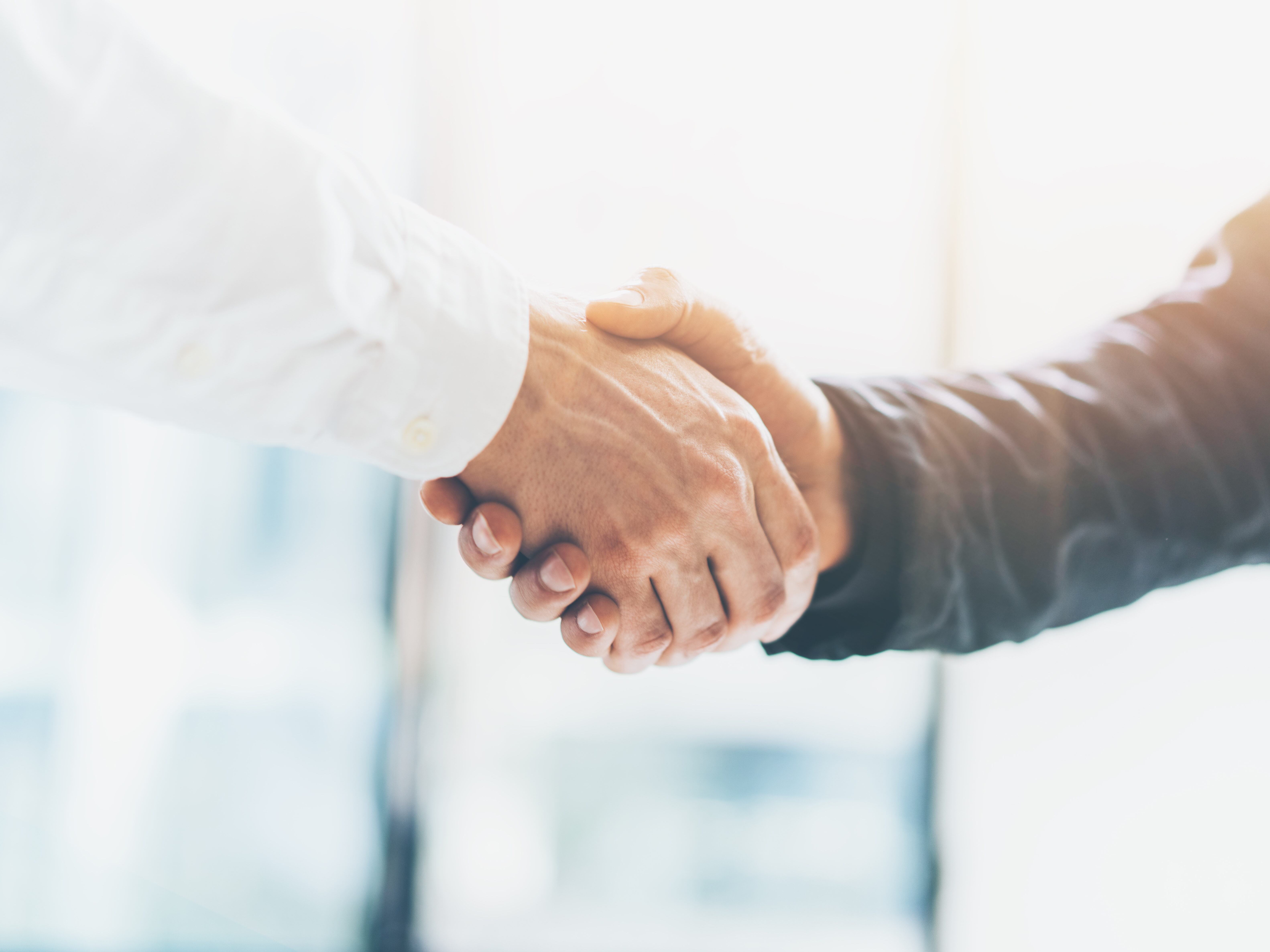 Business partnership meeting. Picture businessmans handshake. Successful businessmen handshaking after good deal. Horizontal, blurred background